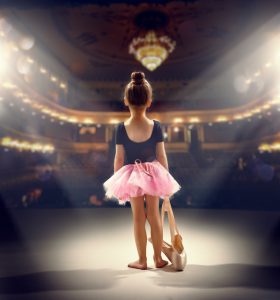 little girl plays in the ballet